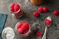 Glass jars with fresh ripe raspberries on table
