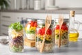 Glass jars with healthy meal on grey marble table