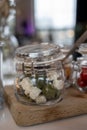 Glass jars with healthy party snacks served in bar, tasty appetisers