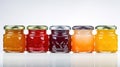 Glass jars with jam of different colors from different fruits. lined up, white background. Eco healthy food. Sweet Royalty Free Stock Photo