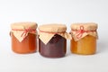 Glass jars with jam on white background Sweet food Royalty Free Stock Photo