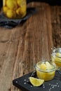 Glass jars with lemon pieces in salt