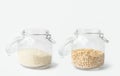 Glass jars with lid filled with dry grains rice oats on white table. Kitchen storage solutions reusable plastic free containers