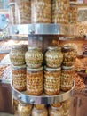 Glass jars with nuts in honey on round stall