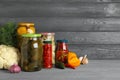 Glass jars with pickled vegetables on wooden table. Space for text Royalty Free Stock Photo