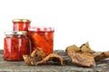 Glass jars with preserved peppers on a wooden background with autumn leaves. Copy space Royalty Free Stock Photo