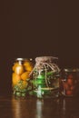 glass jars with preserved vegetables on wooden table Royalty Free Stock Photo