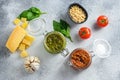 Glass jars with red and green pesto  and cooking italian recipe ingredients  Parmesan cheese, basil leaves, pine nuts, olive oil, Royalty Free Stock Photo