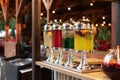 Glass jars with refreshing lemonade at summer party, cocktail bar. Soft selective focus. Big glass jars with tap filled with fresh Royalty Free Stock Photo