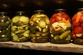 In glass jars, rustic canned delicious vegetables prepared by grandmother for the winter