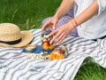 Glass jars with a salad of fruits and berries in the hands of a woman. Seasonal healthy vegetarian food for a picnic. Picnic in Royalty Free Stock Photo