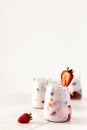 Glass jars with strawberry milkshake