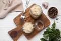 Glass jars with tasty sauerkraut and ingredients on white wooden table, flat lay Royalty Free Stock Photo