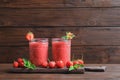 Glass jars with tasty strawberry smoothie Royalty Free Stock Photo