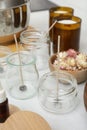 Glass jars with wicks on white kitchen table. Making homemade candles Royalty Free Stock Photo