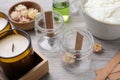 Glass jars with wooden wicks on light table. Making homemade candles Royalty Free Stock Photo