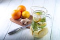 Glass jug of detox water, oranges, lemon and ginger Royalty Free Stock Photo