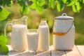 Glass and jug of fresh milk on wooden table Royalty Free Stock Photo