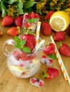 Glass jug full of ice cubes, berries, lemon slices and mint Royalty Free Stock Photo