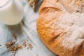 Glass jug with milk and bread on white textile Royalty Free Stock Photo