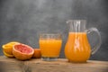 Glass and glass jug with orange juice