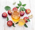 Glass of juice and carafe of fresh apple juice and organic apples on wooden table Royalty Free Stock Photo