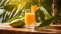 A glass juice glass mango on a background of sea and palm trees tropical table