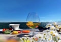 glass of juice cup of coffee , exotic fruits and berry sunglasses on wooden table top at beach cafe resort and wild flowers daisy Royalty Free Stock Photo