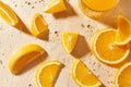 Glass of juice and orange slices on wet table Royalty Free Stock Photo