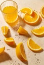 Glass of juice and orange slices on wet table Royalty Free Stock Photo