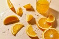 Glass of juice and orange slices on wet table Royalty Free Stock Photo