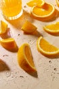 Glass of juice and orange slices on wet table Royalty Free Stock Photo