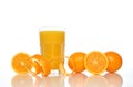 Glass of juice, oranges and orange peel Royalty Free Stock Photo