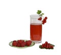 A glass with juice, a raspberry on a saucer and a Royalty Free Stock Photo