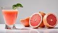 A glass of juice with a slice of grapefruit on top