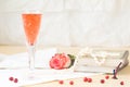 Glass of kir royal cocktail with vintage books and pearls Royalty Free Stock Photo