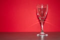 A glass with a red background Royalty Free Stock Photo