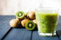 Glass of kiwi juice with fresh fruits on wooden table Royalty Free Stock Photo