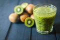 Glass of kiwi juice with fresh fruits on wooden table Royalty Free Stock Photo