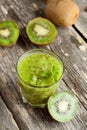 Glass of kiwi juice with fresh fruits on wooden table Royalty Free Stock Photo