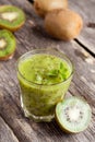 Glass of kiwi juice with fresh fruits on wooden table Royalty Free Stock Photo