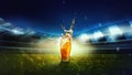 Glass with lager foamy beer on grass at football stadium over evening sky with flashlights. Game and drink Royalty Free Stock Photo