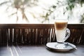 A glass of latte by the beach