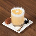 Glass of Latte macchiato coffee with cookies on brown table Royalty Free Stock Photo