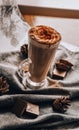 Glass of Latte Macchiato, Delicious hot chocolate, Cup of coffee with cinnamon, chocolate and cream Royalty Free Stock Photo