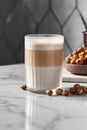 A glass of latte macchiato with hazelnuts Royalty Free Stock Photo