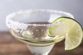 Glass of lemon drop martini  with lime slice on table, closeup Royalty Free Stock Photo