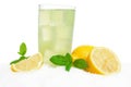 Glass of lemon juice,ice cubes on snow on white Royalty Free Stock Photo