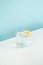 Glass with lemon water on a table.