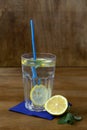 Glass of lemonade with lemon and fresh leafs mint. homemade cold refreshing drink Royalty Free Stock Photo
